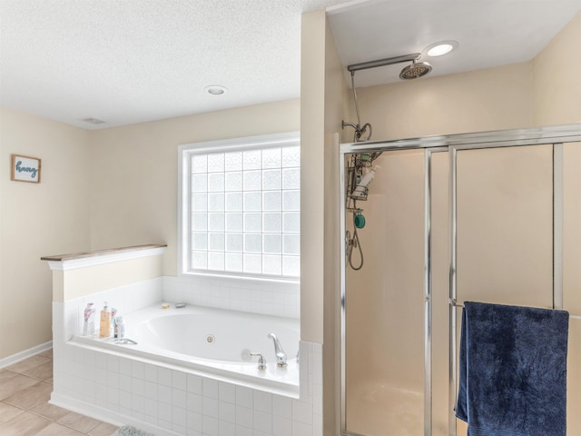 bathroom with tile patterned floors, plus walk in shower, and a textured ceiling