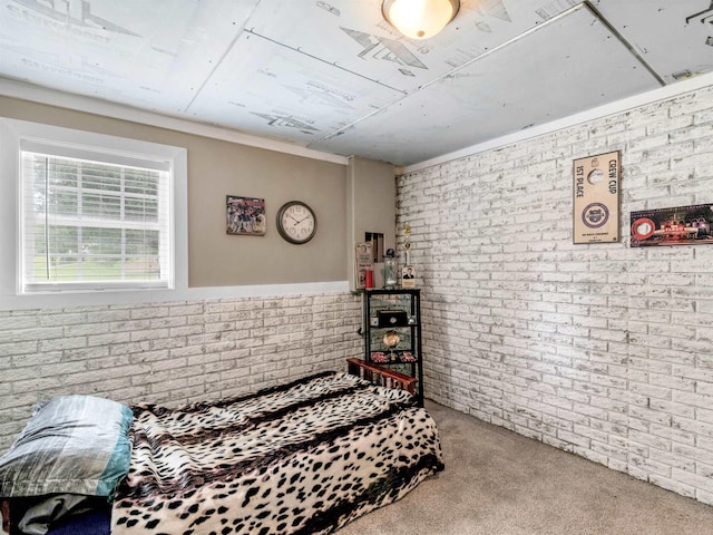 bedroom featuring carpet flooring and brick wall