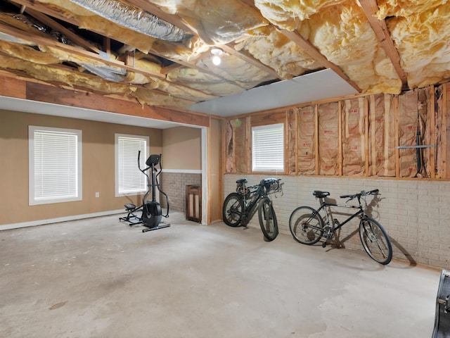 basement featuring a healthy amount of sunlight and brick wall