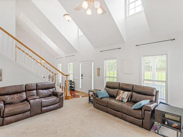 living room with carpet, ceiling fan, and high vaulted ceiling