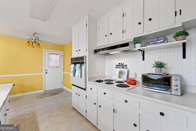 kitchen with white cabinets, light tile patterned floors, white appliances, and ceiling fan