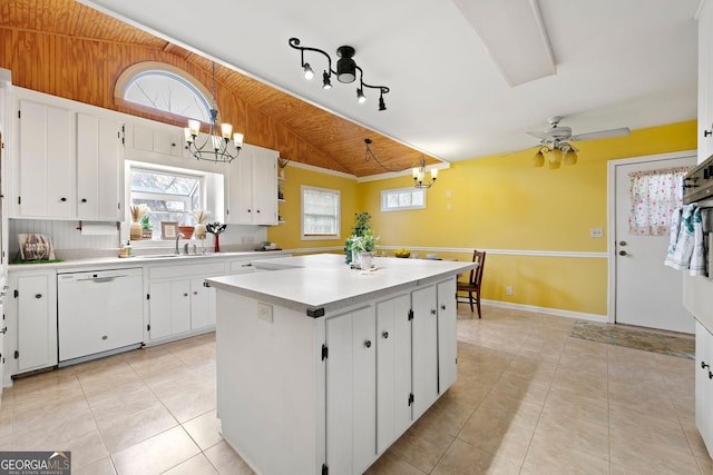 kitchen featuring white cabinetry, a center island, white dishwasher, lofted ceiling, and decorative light fixtures