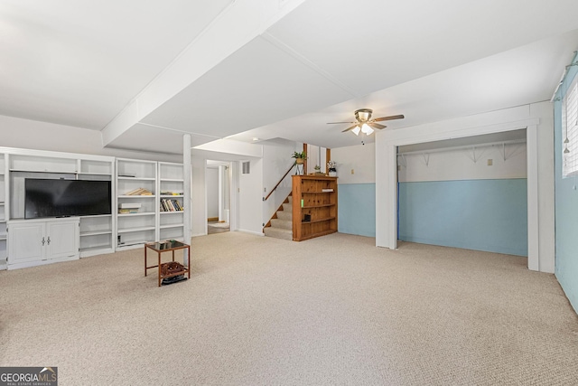 carpeted living room featuring ceiling fan