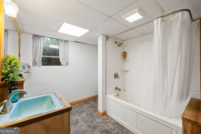 bathroom featuring shower / bath combo, vanity, and a drop ceiling