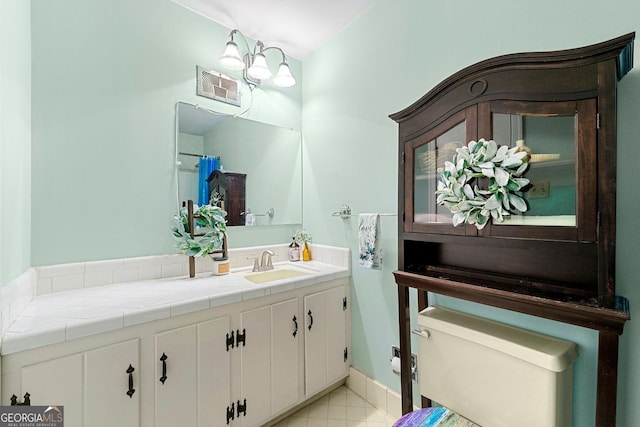 bathroom featuring tile patterned floors, vanity, and toilet