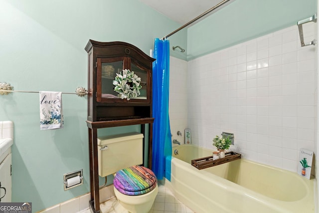 full bathroom featuring tile patterned flooring, vanity, toilet, and shower / bath combo with shower curtain