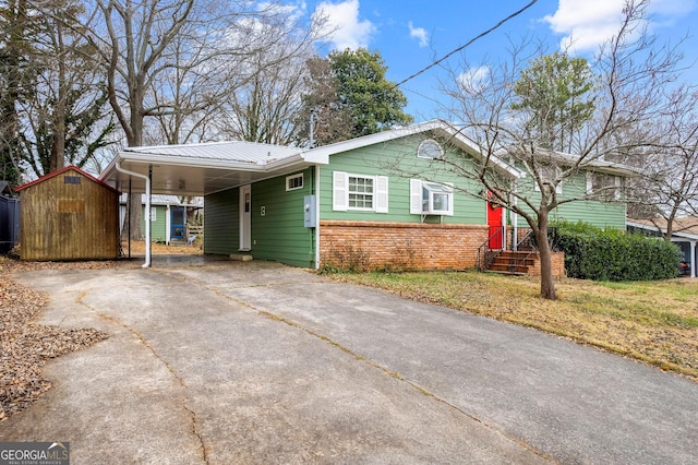 view of front of home featuring a storage shed and a carport