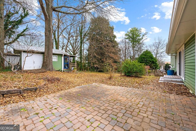 view of patio / terrace featuring a storage unit