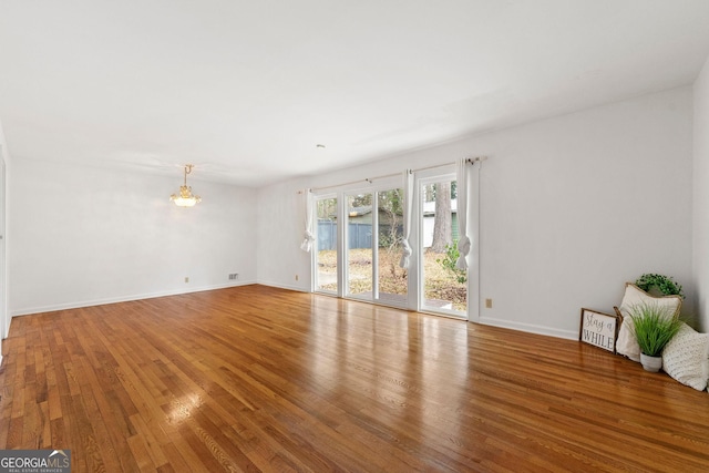 empty room with wood-type flooring