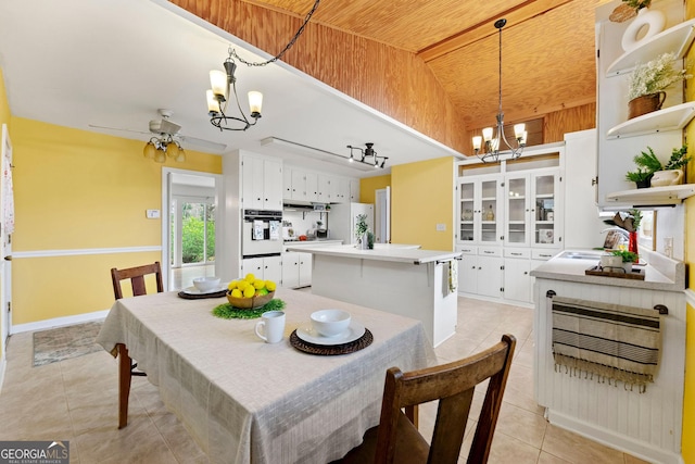 tiled dining space featuring vaulted ceiling, wooden ceiling, and ceiling fan with notable chandelier