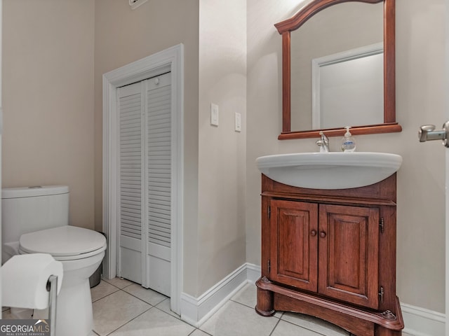 bathroom featuring toilet, vanity, and tile patterned floors