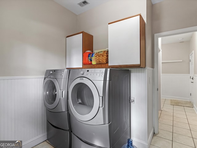 washroom featuring independent washer and dryer and light tile patterned floors