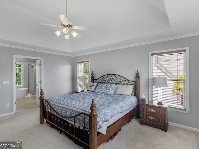 carpeted bedroom featuring a tray ceiling, ceiling fan, and ornamental molding