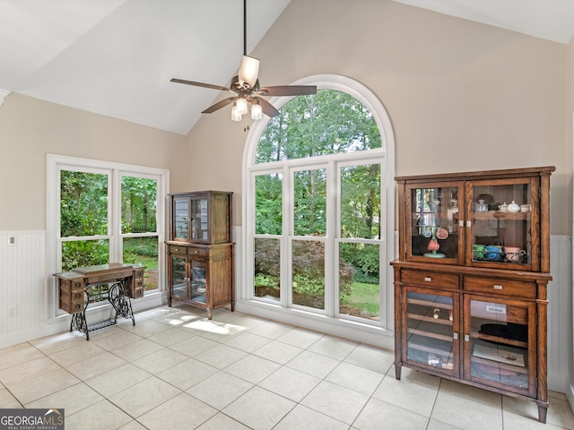 tiled living room featuring ceiling fan and lofted ceiling