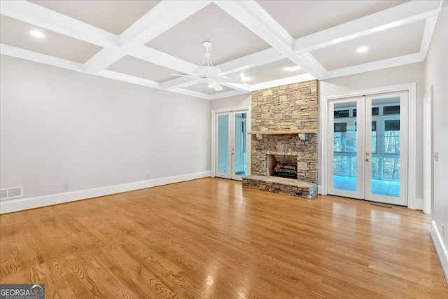 unfurnished living room featuring coffered ceiling, ceiling fan, light hardwood / wood-style flooring, and french doors