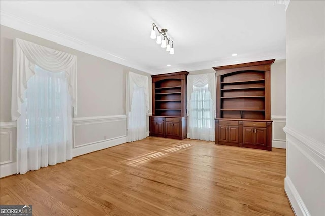 unfurnished living room featuring light hardwood / wood-style floors and ornamental molding