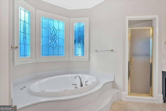 bathroom featuring tile patterned floors and separate shower and tub