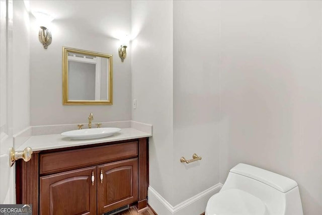 bathroom with vanity and toilet