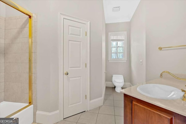 full bathroom featuring tile patterned floors, tiled shower / bath, vanity, and toilet