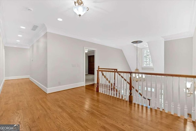 additional living space with light hardwood / wood-style floors and vaulted ceiling