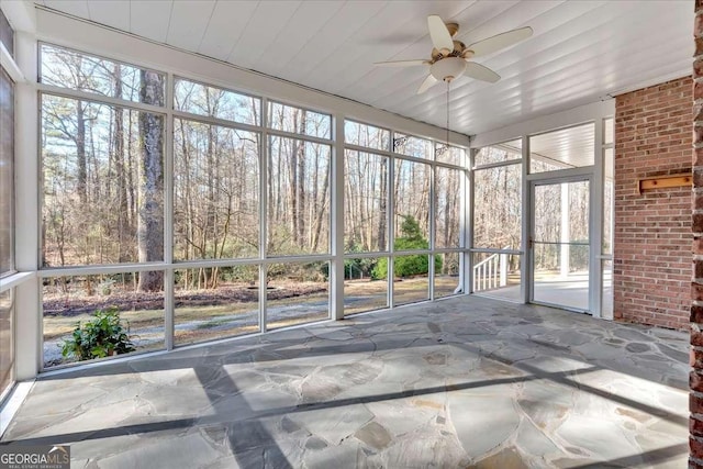 unfurnished sunroom with ceiling fan