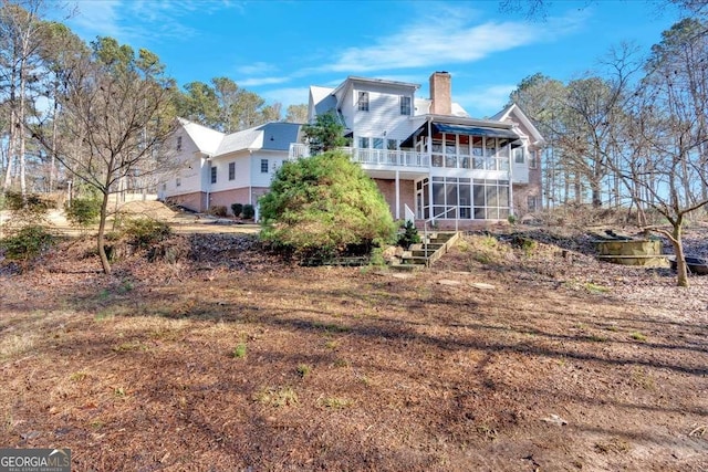 rear view of house with a sunroom