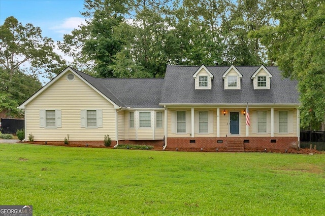 cape cod house with a front lawn