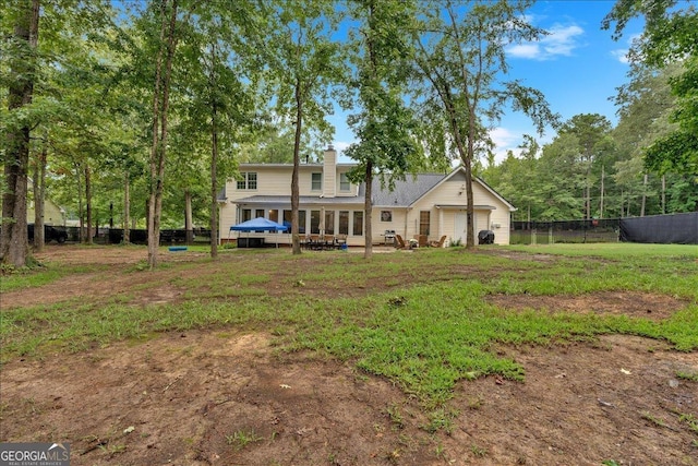 back of property featuring a wooden deck and a garage