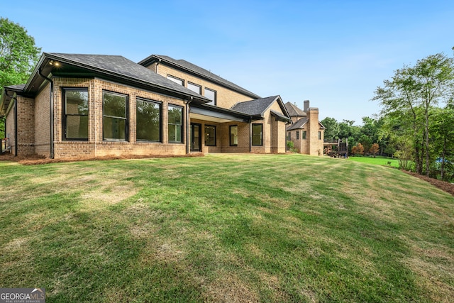 back of house featuring a yard