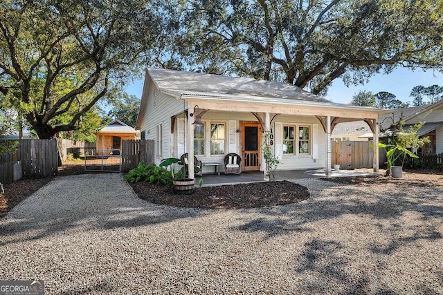 rear view of house featuring a porch