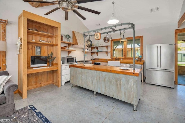 kitchen featuring wooden counters, appliances with stainless steel finishes, ceiling fan, decorative light fixtures, and lofted ceiling