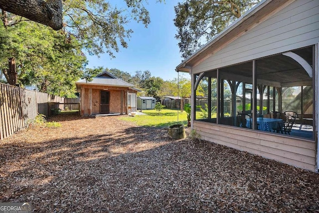 view of yard with a storage unit and a sunroom