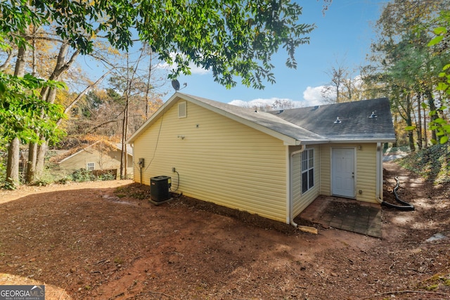 view of side of home with central air condition unit