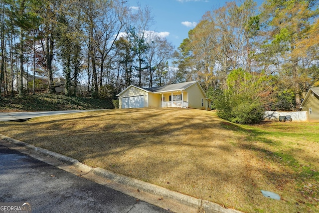 view of front facade featuring a front lawn, a porch, and a garage