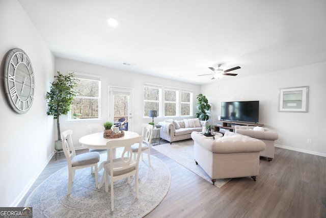 living room featuring hardwood / wood-style flooring and ceiling fan