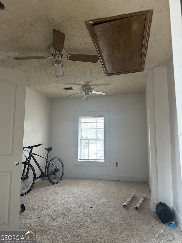 unfurnished room with ceiling fan and light carpet