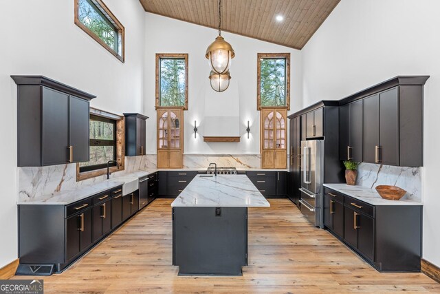 kitchen with a center island, wooden ceiling, decorative light fixtures, backsplash, and stainless steel appliances