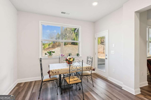 dining space with dark wood-type flooring