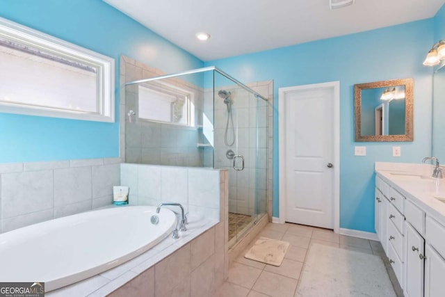 bathroom featuring tile patterned flooring, vanity, and plus walk in shower