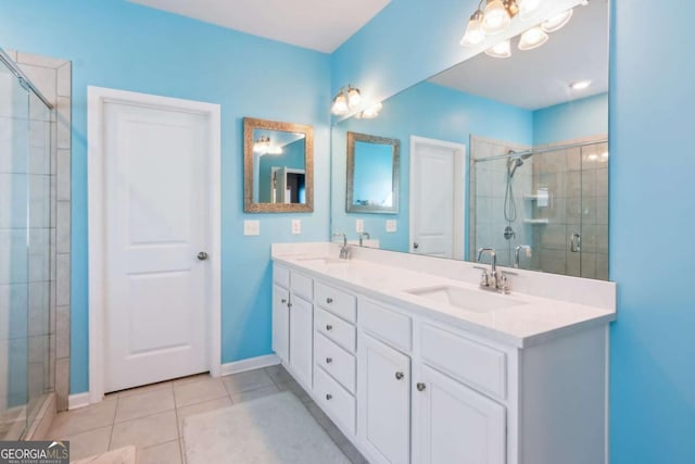 bathroom with tile patterned flooring, vanity, and an enclosed shower