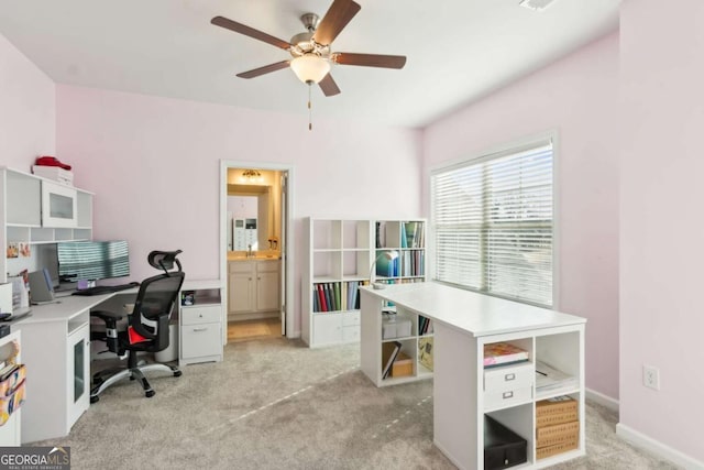 carpeted office featuring ceiling fan