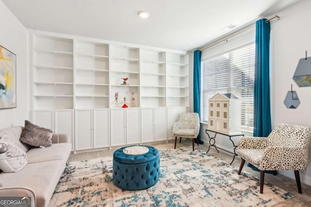 sitting room featuring light colored carpet