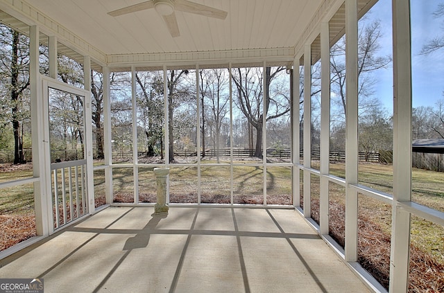 unfurnished sunroom with plenty of natural light and ceiling fan