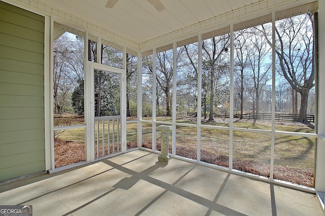 unfurnished sunroom with ceiling fan