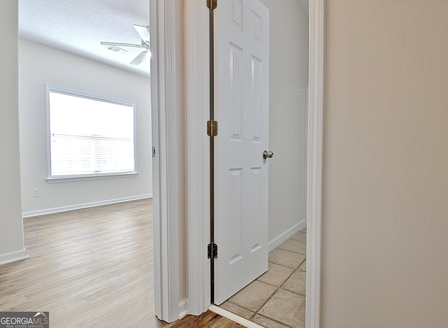 corridor featuring a textured ceiling