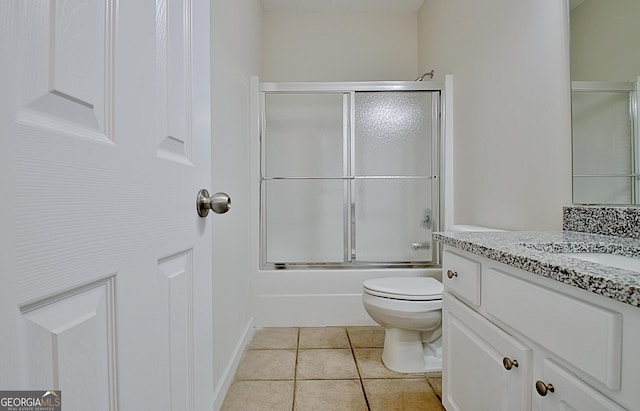 full bathroom with tile patterned floors, vanity, toilet, and combined bath / shower with glass door