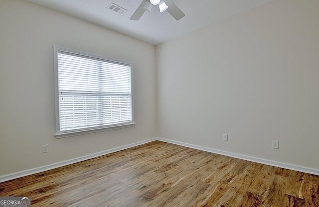 empty room with light wood-type flooring and ceiling fan