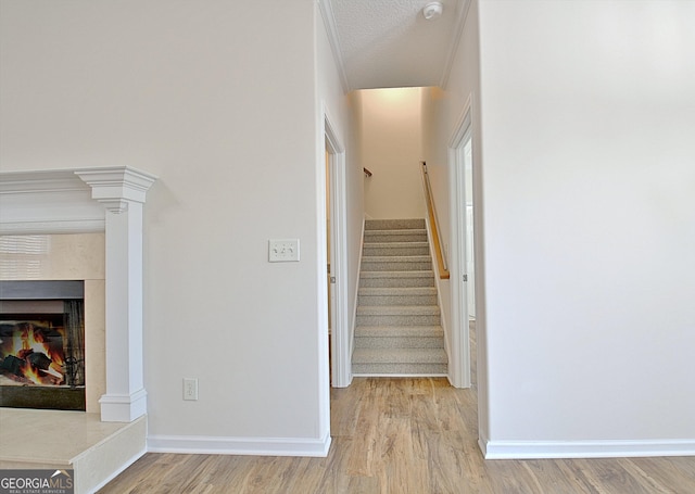 stairs featuring hardwood / wood-style flooring and a textured ceiling