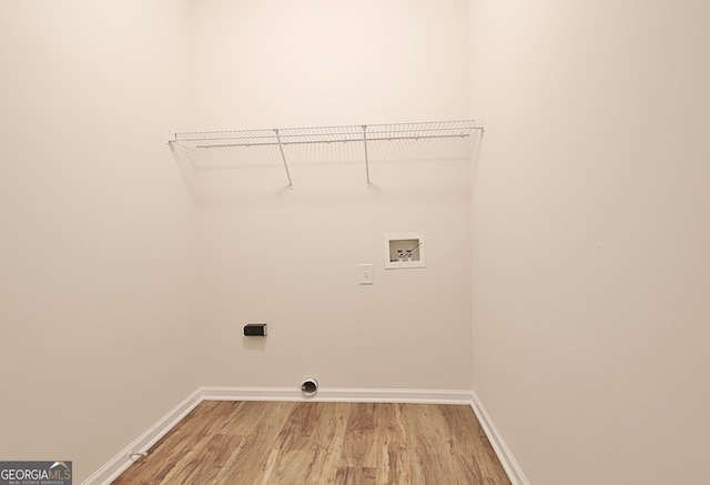 clothes washing area with hookup for a washing machine and hardwood / wood-style flooring