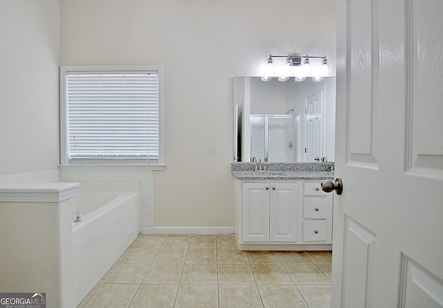 bathroom with tile patterned flooring, shower with separate bathtub, and vanity